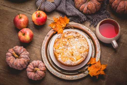 Apple pie with almonds and cup of herbal fruit tea for Thanksgiving.