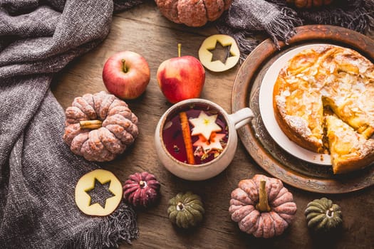 Herbal tea with fruits and cinnamon with apple pie for Thanksgiving.
