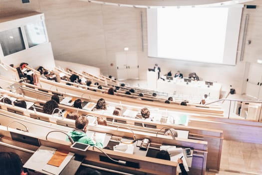 Conference and Presentation. Audience at the conference hall. Business and Entrepreneurship. Faculty lecture and workshop. Audience in the lecture hall. Academic education. Student making notes.