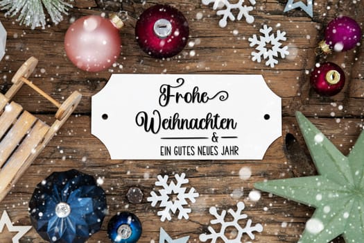 Festive Christmas Decoration, Christmas Background With Snowfall And Sign With German Text Frohe Weihnachten Und Ein Gutes Neues Jahr, Which Means Merry Christmas And Happy New Year In English