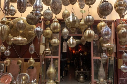 Entrance to a store in Marrakech decorated with traditional lamps in various forms and colors, Morocco