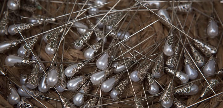 Basket full of pearl head pins. Overhead shot