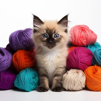 Cute kitten among with balls of yarn on a white background.Generative AI