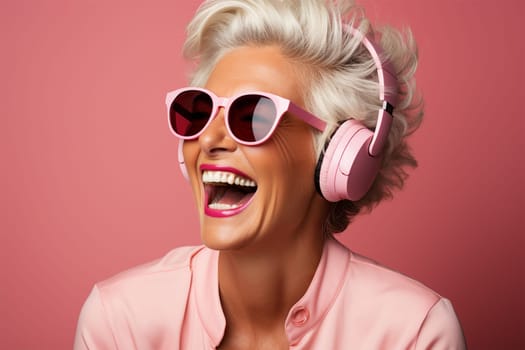 beautiful and cheerful gray-haired woman in glasses, pink clothes and headphones, on a color background.Generative AI