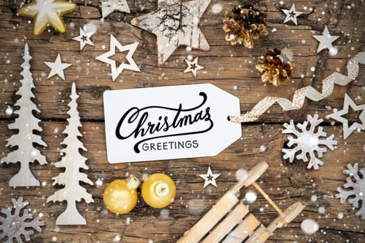 Rustic Wooden And Golden Christmas Background, Christmas Decor With Snowfall And Label With Text Christmas Greetings
