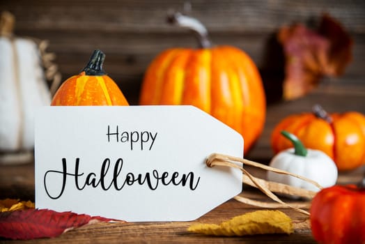 Autumn Decoration With Orange Pumpkins, Rustic fall Decoration With Label Text Happy Halloween