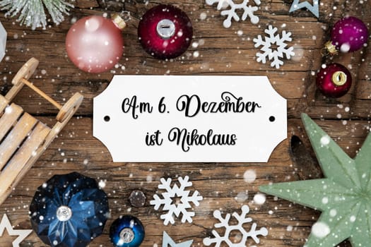 Festive Christmas Decoration, Christmas Background With Snowfall And Sign With German Text Am 6 Dezember Ist Nikolaus, Which Means Saint Nikolaus Day In English