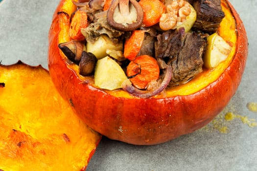 Autumn roasted whole pumpkin stuffed with beef meat, mushrooms, apple and carrots.