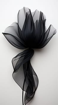 Black satin flower with silk elegant petals on a light background.Generative AI