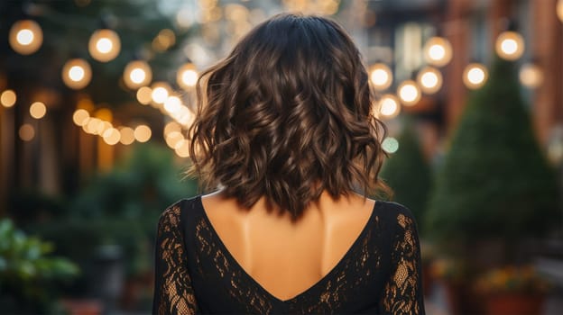 Close-up rear view of a brunette with a shiny wavy hairstyle against the backdrop of an illuminated antique European street.Generative AI