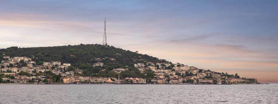 Breathtaking view of the island of Heybeliada with lush forests and traditional houses at sunrise, located in the Sea of Marmara just off the coast of Istanbul, Turkey