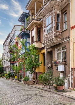 Narrow cobblestone alley with colorful wooden houses, suited in Kuzguncuk neighborhood, Uskudar district, Istanbul, Turkey