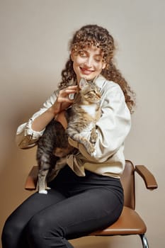 Young woman hugging and stroking her cat