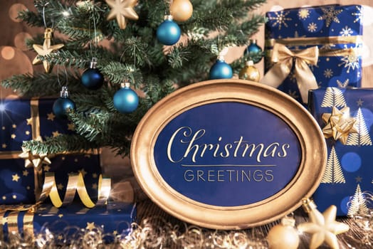 Oval Golden Frame With Text Christmas Greetings, Blue And Golden Decorated Christmas Tree As Winter And Christmas Background