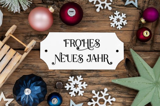 Rustic And Festive Christmas Decoration With White Sign With German Text Frohes Neues Jahr, Which Means Happy New Year