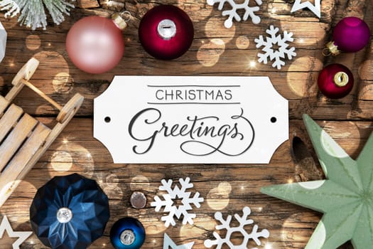 Colorful Christmas Decor With Bokeh, Christmas Balls And Snowflakes, With Sign With Text Christmas Greetings