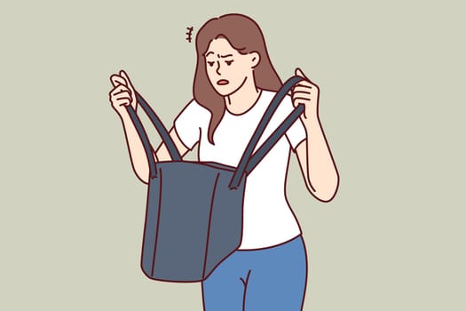 Woman is nervous looking into purse and seeks lost keys or purse forgotten at home. Confused girl stands with bag in hands, and is disappointed after learning about theft of wallet with money