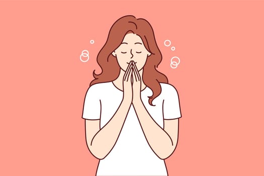 Praying woman performs meditation or religious ritual to purify thoughts and get rid of bad emotions. Casual girl stands with eyes closed and does meditation to achieve balance between body and soul