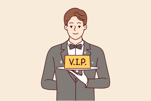 Man restaurant waiter holds vip sign on tray, offering to book table with personalized service. Guy in suit and white gloves works as professional waiter in catering company with vip clients.