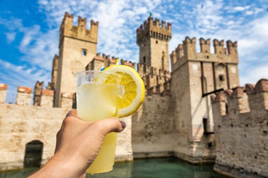 Hand with fresh cold lemonade. Concept for enjoy, relaxation, travel, summer