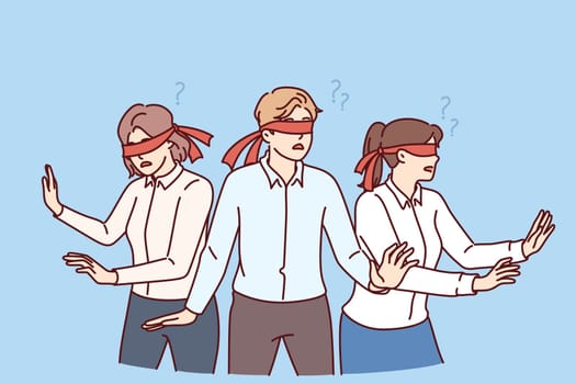 Business people with blindfolds look in different directions, symbolizing lack of coherence between company employees. Man and two female office workers are having trouble coordinating