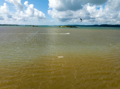 GETSKAR, SWEDEN - JULY 30, 2023: Kite surfer flying over the water at the Getskar surfspot on the west coast of Sweden.