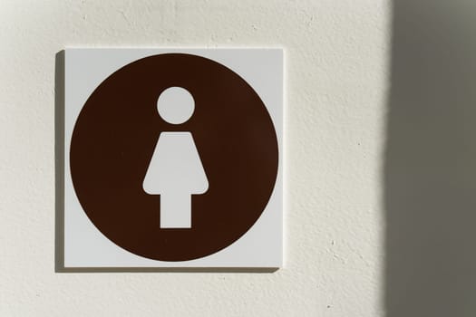 Toilet for women with the symbol of a woman on the entrance door