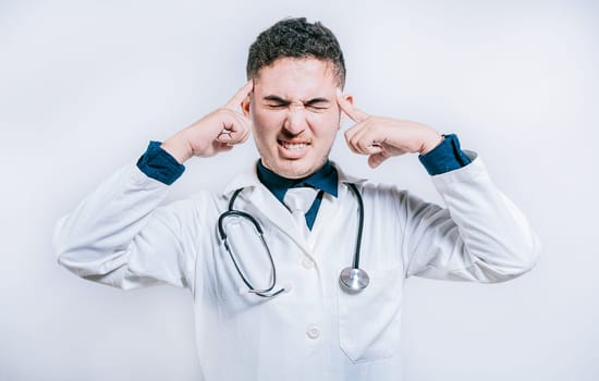 Doctor with migraine holding his head. Fatigued doctor with headache isolated, Young Doctor with headache isolated