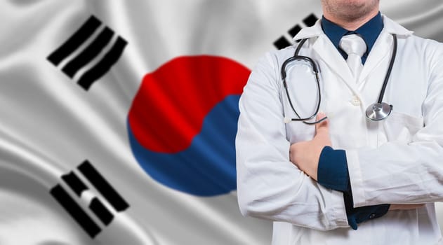 Doctor with crossed arms on South Korean flag. Medical health and care on South Korean flag. Doctor with stethoscope on South Korean flag
