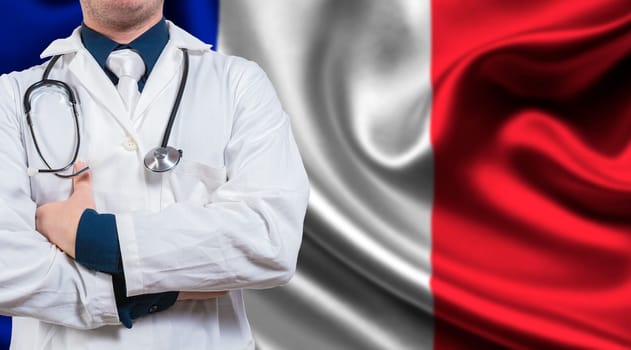 Doctor with stethoscope on France flag. Doctor with arms crossed on France flag background. Medical health and care on French flag