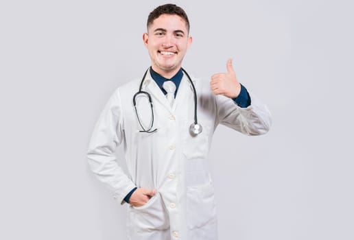 Happy doctor giving thumb up isolated. Handsome doctor with thumb up smiling isolated. Latin doctor with thumbs up gesture