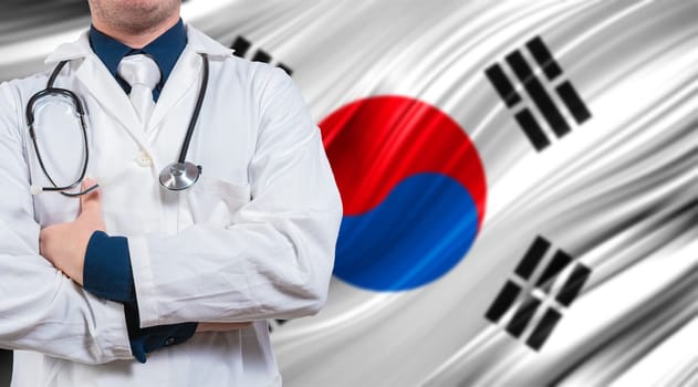 Doctor with stethoscope on South Korean flag. Doctor with crossed arms on South Korean flag. Medical health and care on South Korean flag