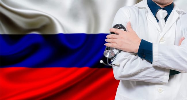 Doctor with stethoscope on Russian flag. Doctor with crossed arms on Russian flag. Medical health and care on background Russian flag