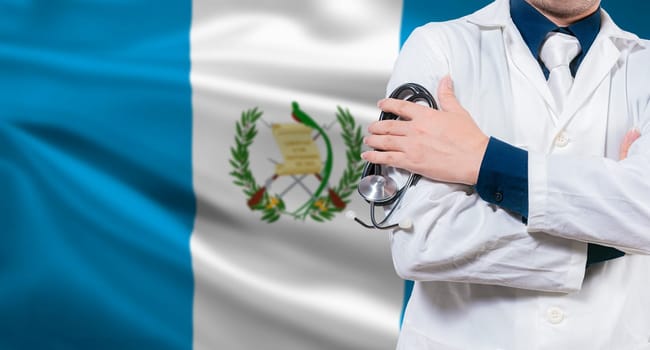 Doctor with stethoscope on guatemalan flag. Doctor arms crossed with stethoscope on Guatemalan flag, Guatemala national health concept