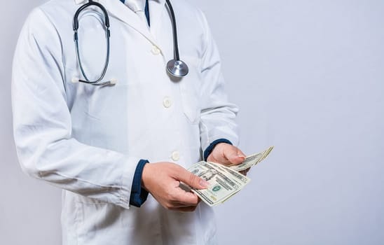 Medical corruption concept. Corrupt doctor counting money isolated, hands of corrupt doctor counting money on isolated background