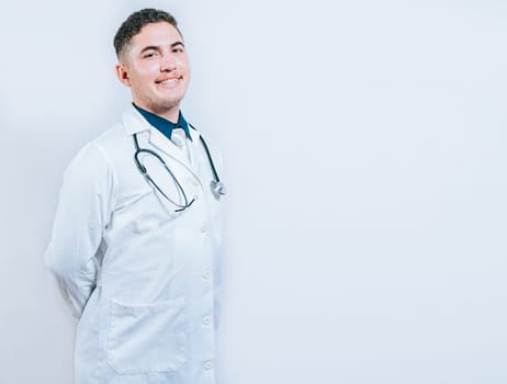Portrait of smiling young doctor isolated. Portrait of latin doctor isolated with copy space