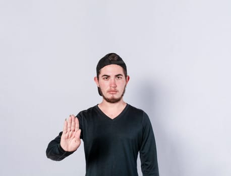 Serious young man stop sign with palm, caucasian man stop sign with hand, stop concept with hand