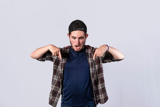 A man pointing down, surprised guy pointing his fingers down, amazed young man pointing down