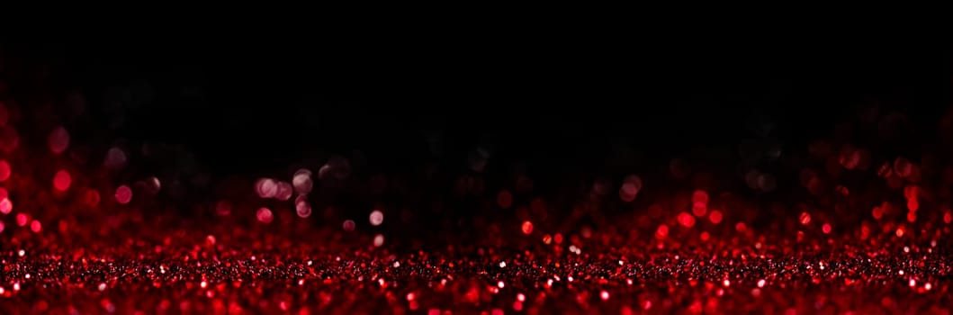 Abstract blur red glitter on black background. Card for Valentine's day, christmas and wedding celebration. Love bokeh sparkle confetti textured layout. Classy elegant design.
