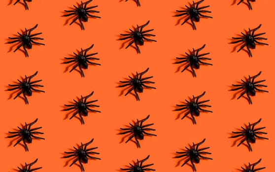 Halloween background pattern. Scary black spider on orange paper. Minimal pop art design for halloween party concept.