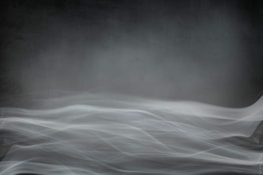 Spooky dark Halloween background banner design with copyspace. Abstract smoke on grunge textured backdrop.