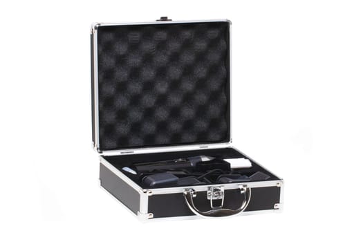 Closeup of a opened small black silver equipment case or suitcase with professional hairdresser's set isolated on a white background.