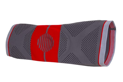 Knee pads isolated. Close-up of a red gray sports elastic knee pad or bandage to fixing and supporting joints. Clipping path. Volleyball, jogging, running or Fitnesstraining.