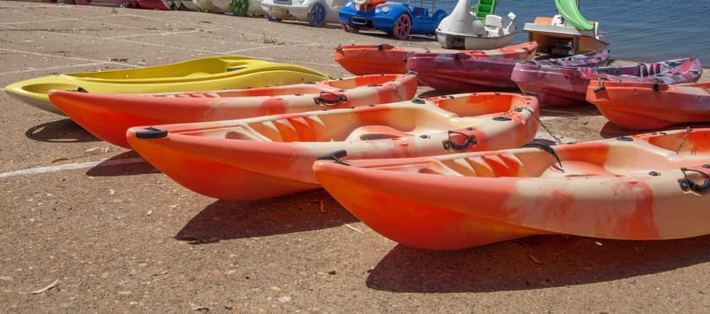 Orellana, Spain - August 4th, 2023: Costa Dulce de Orellana, unique inland beach in Spain awarded with the Blue Flag, Badajoz, Spain. Kayak boats for rent