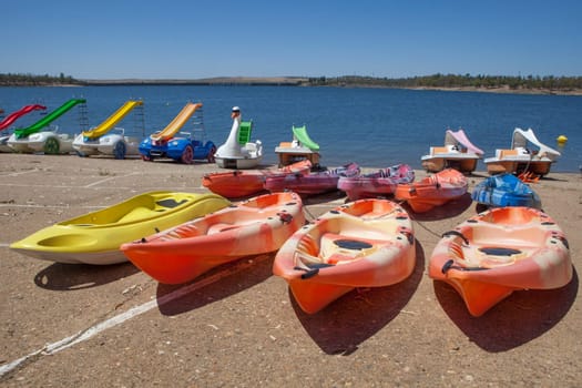 Orellana, Spain - August 4th, 2023: Costa Dulce de Orellana, unique inland beach in Spain awarded with the Blue Flag, Badajoz, Spain. Kayaks and pedal boats for rent
