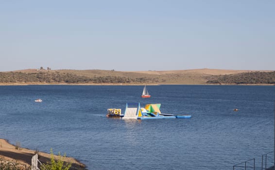 Costa Dulce de Orellana, unique inland beach in Spain awarded with the Blue Flag, Badajoz, Spain. inflatable water park