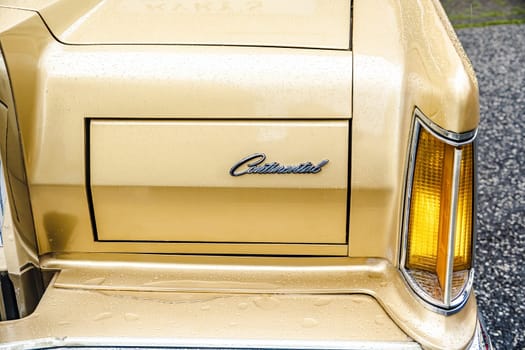 WETTENBERG, HESSE, GERMANY - 07 - 28 - 2023: Detail from golden metallic LINCOLN CONTINENTAL on a traditional Car Show Golden Oldies.