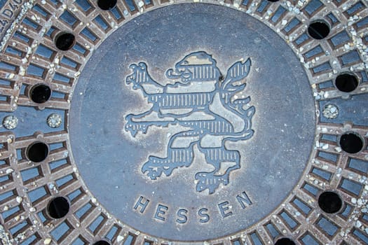WEILBURG, GERMANY - 06-28-2023 - Manhole cover with coat of arms of Hesse Germany