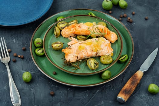 Roasted salmon fillet steak with mini kiwi. Mediterranean diet concept.