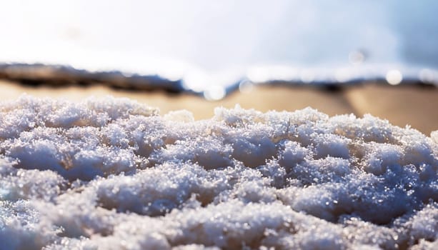 A rock surrounded with cracked ice and ice hummocks during sunrise on beautiful winter frozen Baikal lake